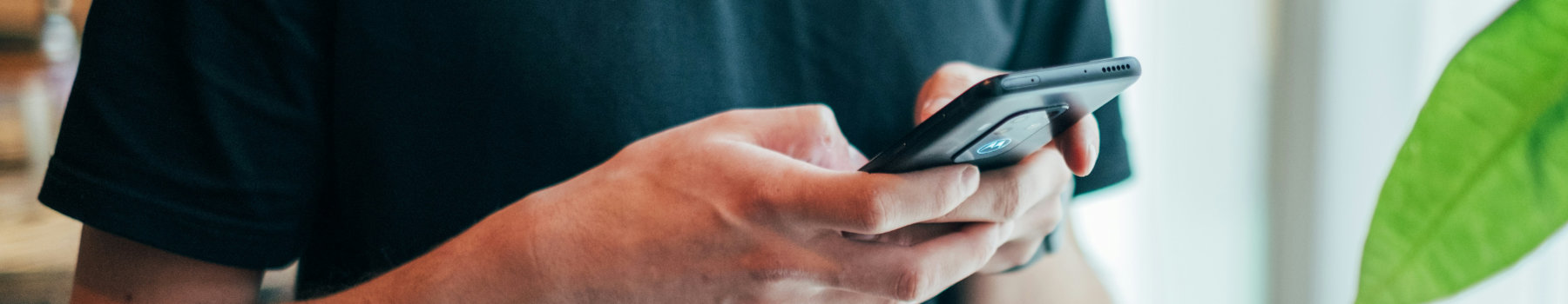 A close up shot of a pair of hands holding a mobile phone