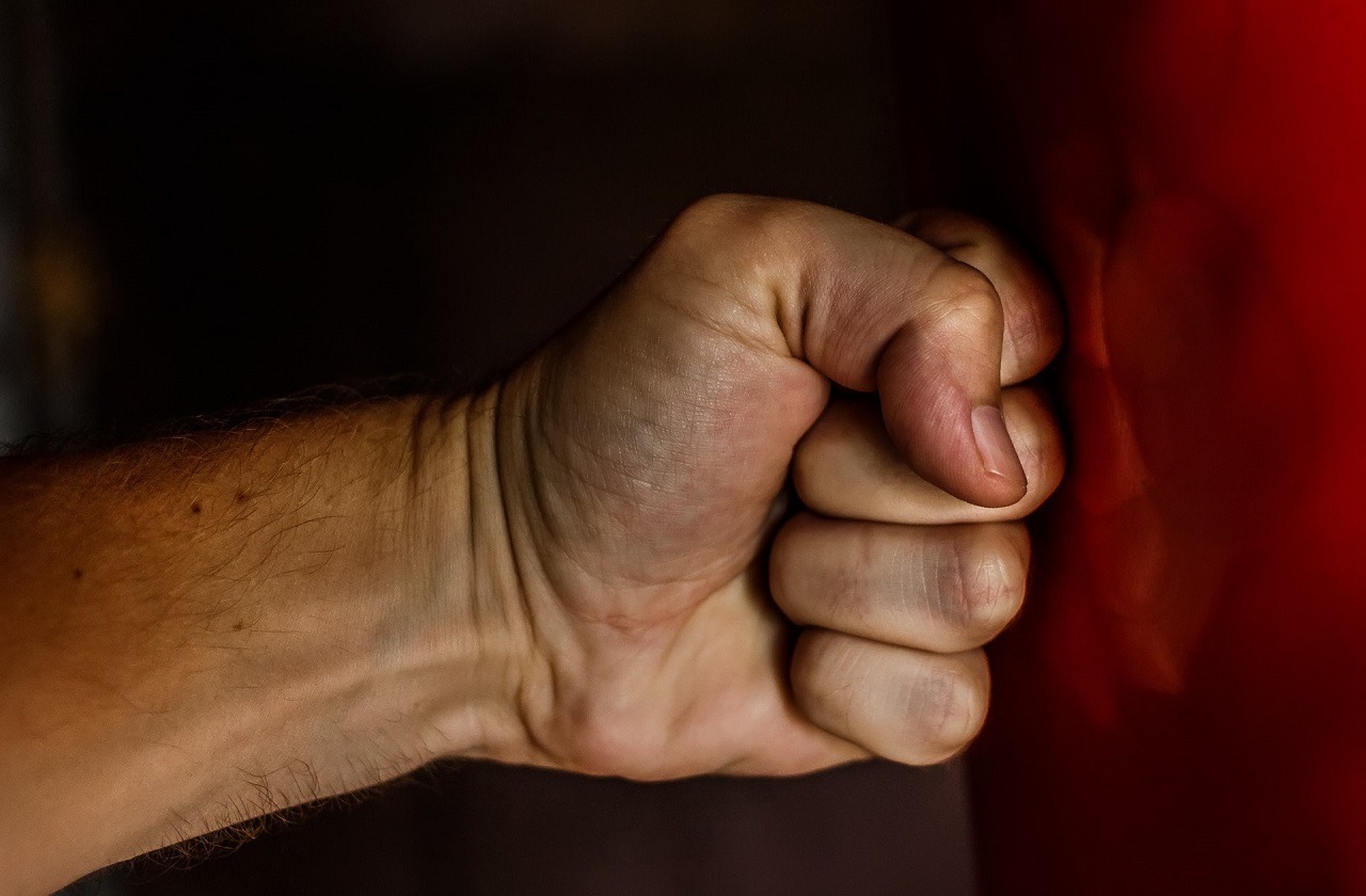 A fist punching a wall