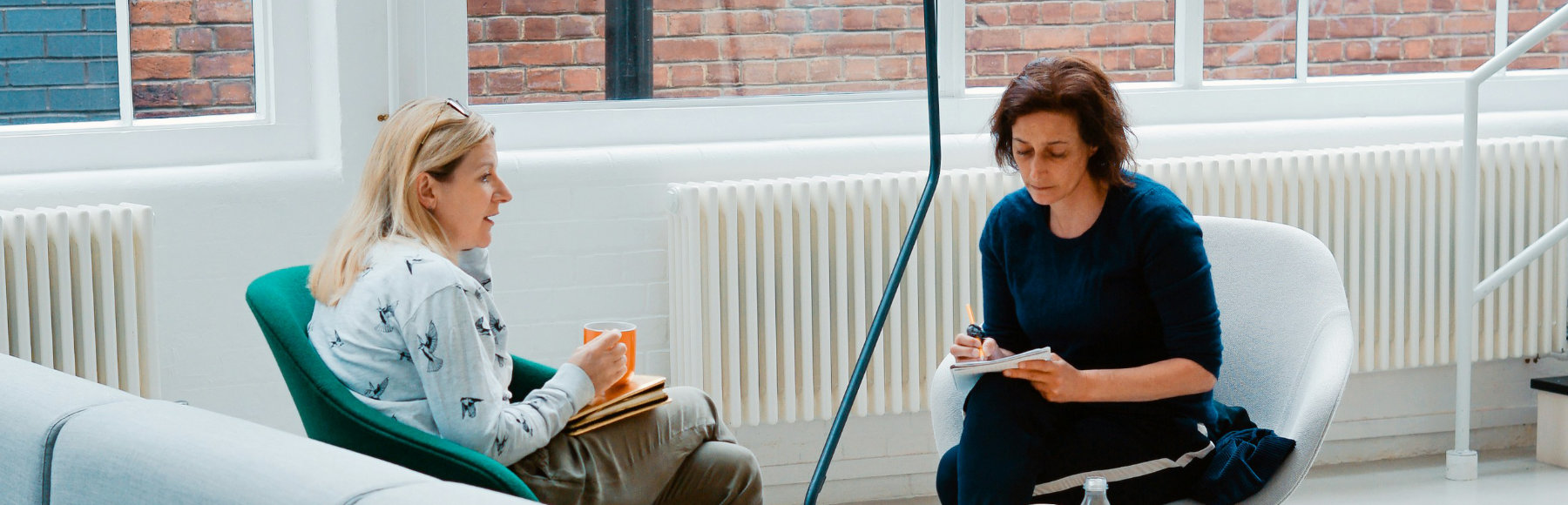 Two women having a discussion in an office